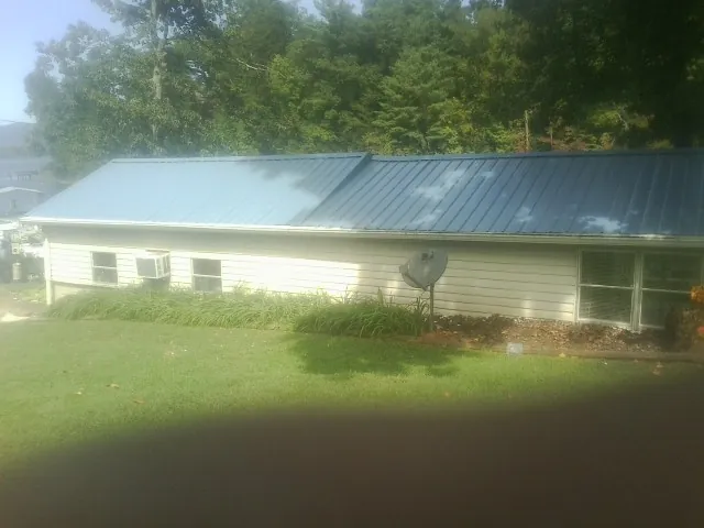 Blue metal roof running the length of a single story home in Little River Academy